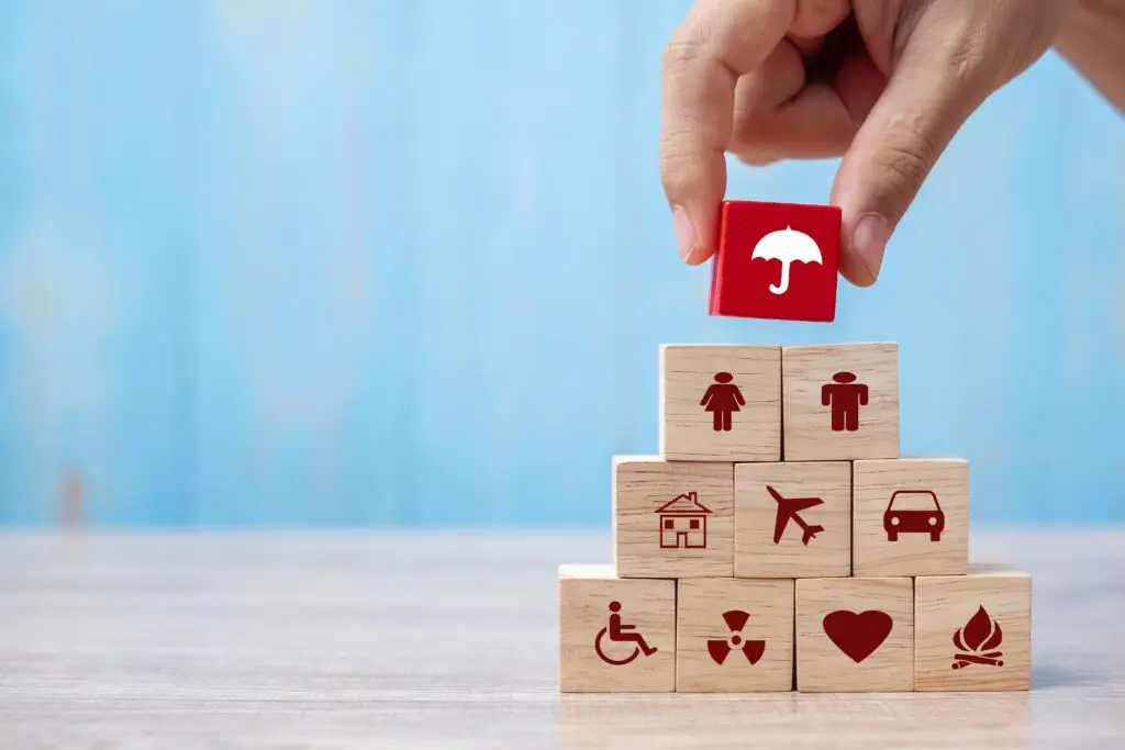 hand holding umbrella wood block cover insurance icon. healthcar