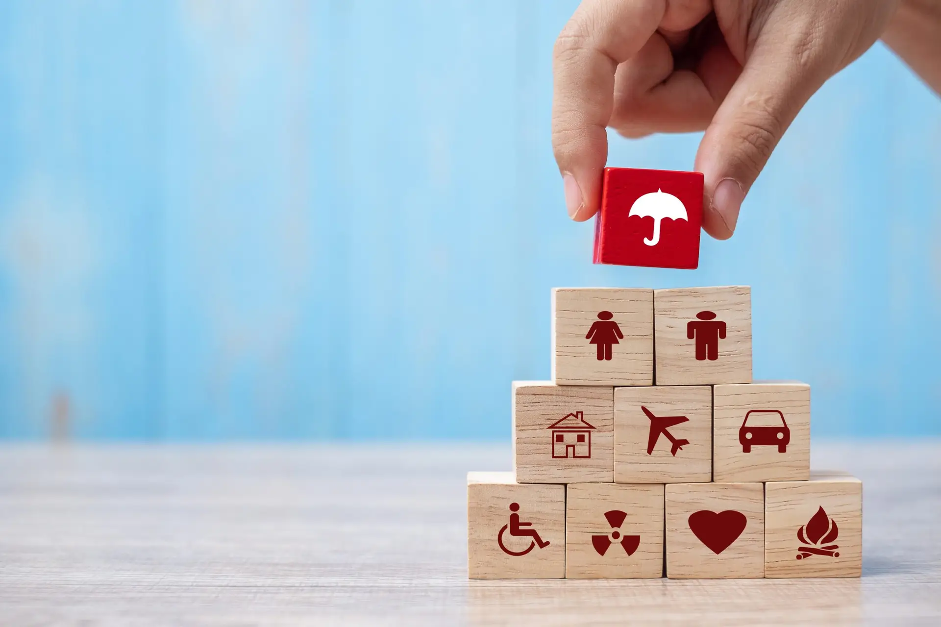 hand holding umbrella wood block cover insurance icon. healthcar
